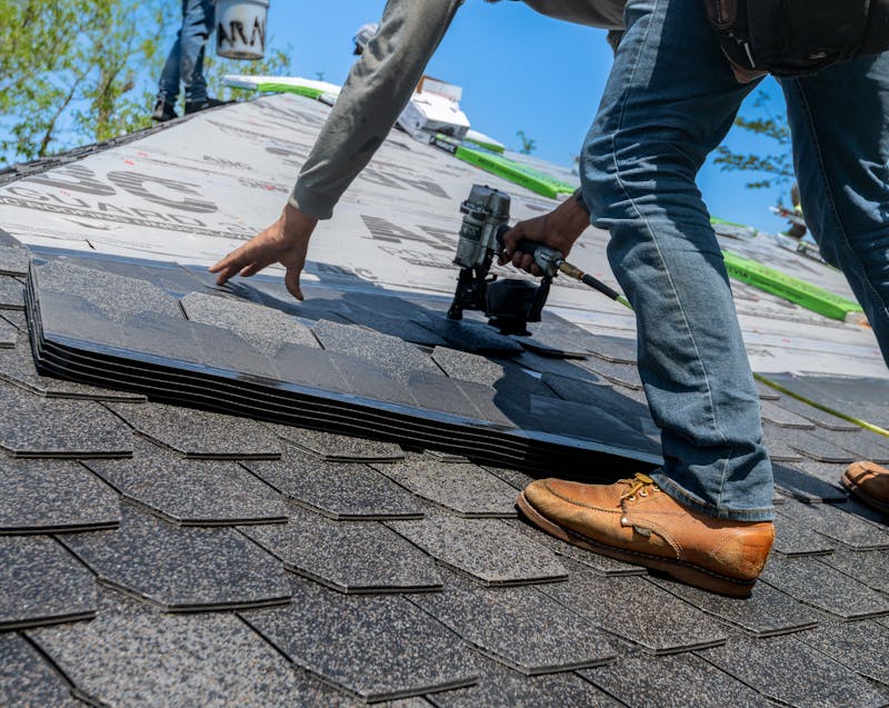 a man installing roof shingles